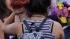 Two people hug Saturday, July 21, 2012, at a...
