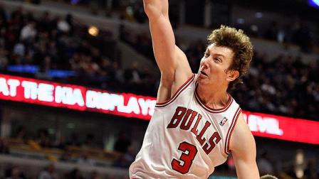 In this Feb. 22, 2012, file photo, Chicago Bulls Omer Asik (3) dunks the ball over Milwaukee Bucks Beno Udrih (19) during the second half of an NBA basketball game in Chicago. (AP Photo/Jim Prisching, File)
