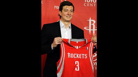 New Houston Rockets center Omer Asik, from Turkey, poses with his new jersey during an NBA basketball news conference, Thursday, July 26, 2012, in Houston. Asik signed a three-year, $25 million offer sheet and came to Houston when his former team, the Chicago Bulls, did not match. (AP Photo/Pat Sullivan)