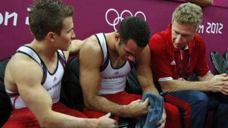 U.S. gymnast Danell Leyva is comforted by teammate Jonathan Horton at the end of the Artistic Gymnastic mens team final at the 2012 Summer Olympics, Monday, July 30, 2012, in London. (AP Photo/Matt Dunham)