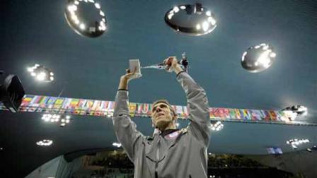 United States swimmer Michael Phelps holds up a silver trophy after being honored as the most decorated Olympian at the Aquatics Centre in the Olympic Park during the 2012 Summer Olympics in London, Saturday, Aug. 4, 2012. Phelps was honored with a special individual ceremony after concluding his record-breaking career Saturday as the most decorated Olympian. Phelps pushed the United States in front to win the medley relay Saturday in the final swimming event of the London Games, after which he is retiring. (AP Photo/Matt Slocum)