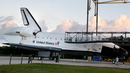 Space shuttle Endeavour enters the mate/demate structure at the Kennedy Space Center landing facility where it will be mounted on a modified jumbo jet, Friday, Sept. 14, 2012, in Cape Canaveral, Fla. On Monday morning, Endeavour will make a four-day trip to Los Angeles atop the jumbo jet bound for the California Science Center.(AP Photo/John Raoux)
