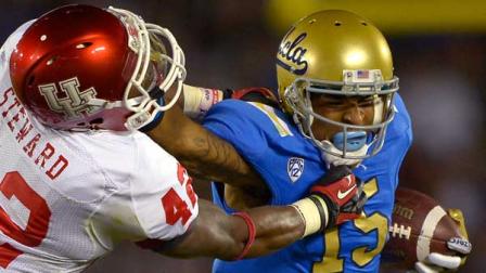 UCLA wide receiver Devin Lucien, right, fends off Houston linebacker Phillip Steward during the second half of their NCAA college football game, Saturday, Sept. 15, 2012, in Pasadena, Calif. (AP Photo/Mark J. Terrill)