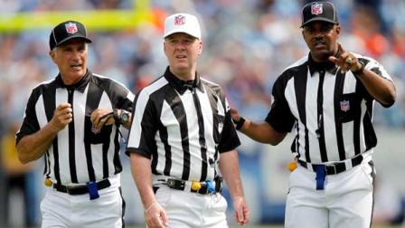 In this Sept. 25, 2011, file photo, officials confer in the third quarter of an NFL football game between the Denver Broncos and the Tennessee Titans in Nashville, Tenn. The NFL and referees union reached a tentative agreement on Wednesday, Sept. 26, 2012, to end a three-month lockout that triggered a wave of frustration and anger over replacement officials and threatened to disrupt the rest of the season. (AP Photo/Wade Payne, File)