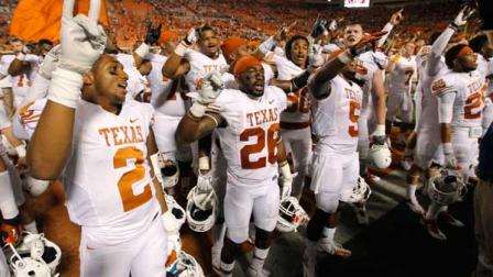 Texas players celebrate with their fans following a 41-36 victory over Oklahoma State in an NCAA college football game in Stillwater, Okla., Saturday, Sept. 29, 2012. (AP Photo/Sue Ogrocki)