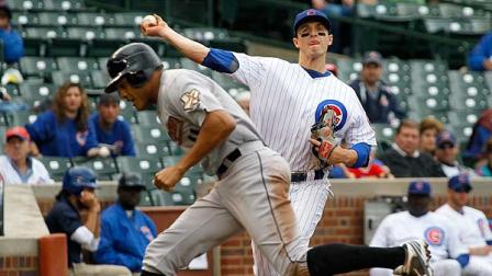 Chicago Cubs third baseman Josh Vitters, right, throws out Houston Astros Brandon Barnes at first as Justin Maxwell ducks the throw during the third inning of a baseball game Wednesday, Oct. 3 2012, in Chicago. (AP Photo/Charles Rex Arbogast)