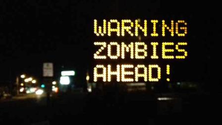 In a photo provided by WGME/TV, a sign at a road construction site was changed by a hacker to read Warning Zombies Ahead! in Portland, Maine, Wednesday, Oct. 10, 2012. It originally read Night work 8 pm-6 am. Expect delays. Drivers may have gotten a chuckle out of an electronic message board in Maine warning of zombies, but city officials were not amused. (AP Photo/Jeff Peterson, WGME/TV)