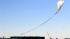 The capsule and attached helium balloon carrying...