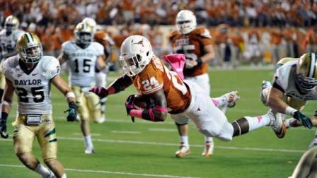Texas running back Joe Bergeron (24), center, dives into the end zone for a touchdown against Baylor safety Sam Holl, left, and linebacker Bryce Hagar, right, in the first quarter of an NCAA college football game on Saturday, Oct. 20, 2012, in Austin, Texas. (AP Photo/Michael Thomas)