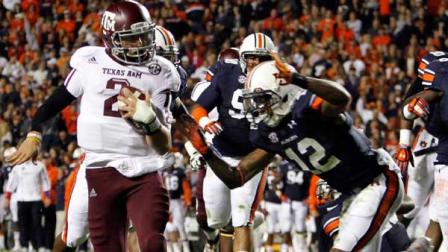 Texas A&M quarterback Johnny Manziel (2) runs in for a touchdown past Auburn defensive back Demetruce McNeal (12) during the first half of an NCAA college football game on Saturday, Oct. 27, 2012, in Auburn, Ala. (AP Photo/Butch Dill)