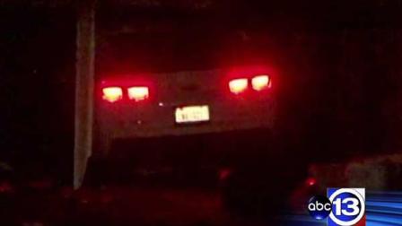 Police say the driver of this Camaro fled on foot after crashing through a fence and into a Halloween party, killing one person and injuring three others