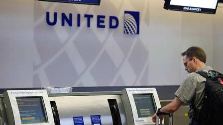 In this July 13, 2011 photo, a man uses a United Airlines check-in kiosk at San Francisco International Airport in San Francisco. (AP Photo/Eric Risberg)