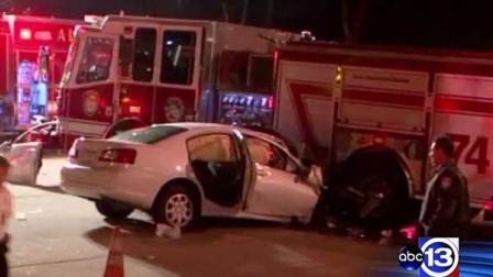 Police say the driver of this white car died after colliding with the fire truck