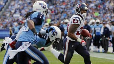 Houston Texans running back Arian Foster (23) scores a touchdown on a 2-yard run as Tennessee Titan defenders Michael Griffin (33) and Akeem Ayers, center, pursue him in the second quarter of an NFL football game on Sunday, Dec. 2, 2012, in Nashville, Tenn. (AP Photo/Joe Howell)