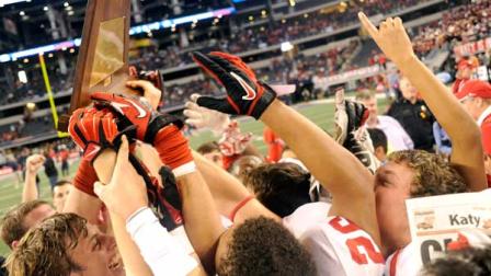 Katy players celebrate withe the championship trophy after their 35-24 win over Cedar Hill during a UIL Class 5A Division II high school football championship game, Saturday, Dec. 22, 2012, in Arlington, Texas. (AP Photo/Matt Strasen)
