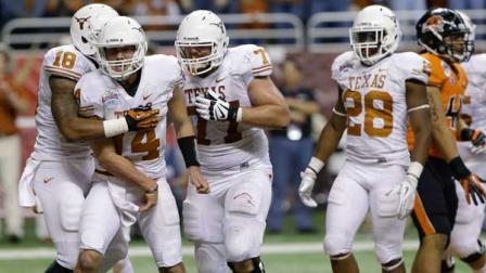 Texas David Ash, second from left, celebrates with teammates after he scored during the third quarter of the Alamo Bowl NCAA football game against Oregon State, Saturday, Dec. 29, 2012, in San Antonio. Texas won 31-27. (AP Photo/Eric Gay)