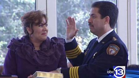 Sheriff Adrian Garcia raises his right hand as he is sworn in for a second term