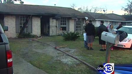 A family stands outside their destroyed home after a fire Saturday morning. Luckily, no one was injured in the blaze, officials said.