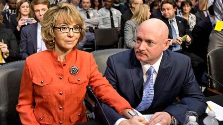 Former Arizona Rep. Gabrielle Giffords, who was seriously injured in the mass shooting that killed six people in Tucson, Ariz. two years ago, sits with her husband, Mark Kelly, right, a retired astronaut, on Capitol Hill in Washington, Wednesday, Jan. 30, 2013, prior to speaking before the Senate Judiciary Committee hearing on what lawmakers should do to curb gun violence in the wake of last months shooting rampage at that killed 20 schoolchildren in Newtown, Ct. (AP Photo/J. Scott Applewhite)