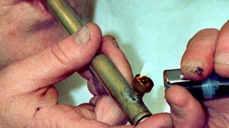 A woman lights a pipe full of marijuana (AP Photo/Don Ryan)
