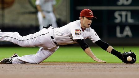 Houston Astros shortstop JedLowrie dives for a hit by Philadelphia Phillies Jimmy Rollins during the first inning of a baseball game on Saturday, Sept. 15, 2012, in Houston. Rollins was safe at first with a single. (AP Photo/David J. Phillip)