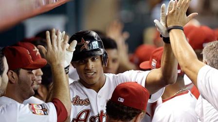Houston Astros Justin Maxwell, center, is congratulated in the dugout after hitting a two-run home run during the first inning of a baseball game against the Philadelphia Phillies, Saturday, Sept. 15, 2012, in Houston. Astros Jose Altuve also scored on Maxwells home run. (AP Photo/David J. Phillip)