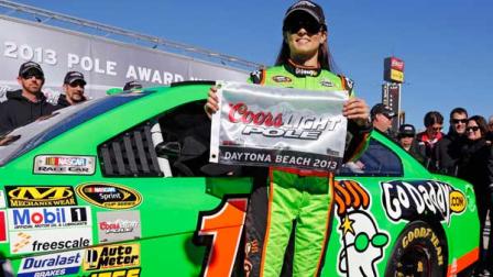 Danica Patrick displays the flag after winning the pole during qualifying for the NASCAR Daytona 500 Sprint Cup Series auto race at Daytona International Speedway, Sunday, Feb. 17, 2013, in Daytona Beach, Fla. Patrick became the first woman to secure the top spot for any Sprint Cup race. (AP Photo/Terry Renna)