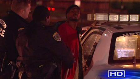 Houston police place a handcuffed man in the back of an HPD cruiser. The man, who has not been identified, allegedly led police on a chase around the 610 Loop
