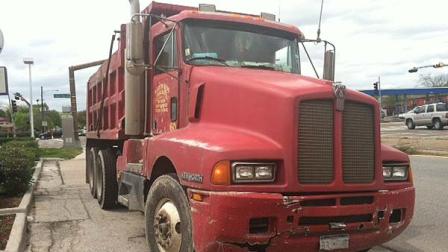 Witnesses say the man walked into the street in front of the dump truck