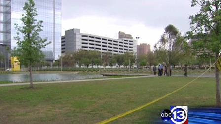 Police surround the Discovery Green pond after a body was pulled from the water on Easter morning