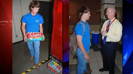 Cypress Woods High School junior Jordan Davis loads bottled water into a designated area in the schools FFA garage, and discusses the relief efforts with assistant principal Barry Cooper.