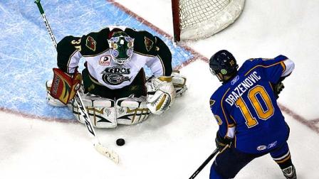 Houston Aeros Goalie, Anton Khudobin (30), makes a save as Peoria Rivermens Nicholas Drazenovic (10) shoots during the first period of the AHL hockey playoff game Saturday, April 18, 2009, in Houston. (AP Photo/Houston Chronicle, Michael Paulsen )