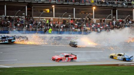 Elliott Sadler (11), Mike Wallace (01), Justin Allgaier (31), Alex Bowman (99), and Landon Cassill (4) spin through the tri-oval near the end of the NASCAR Nationwide Series auto race at the Talladega Superspeedway in Talladega, Ala., Saturday, May 4, 2013. (AP Photo/Rainier Ehrhardt)