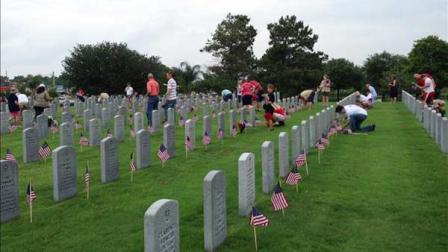 Hundreds of volunteers from various organizations helped placed flags at the graves at the Houston National Cemetery to honor veterans this Memorial Day weekend.