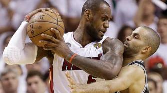 San Antonio Spurs point guard Tony Parker (9) and Miami Heat small forward LeBron James (6) collide during the second half of Game 6 of the NBA Finals basketball game, Tuesday, June 18, 2013 in Miami. (AP Photo/Lynne Sladky)