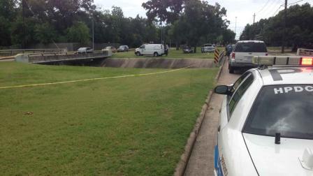 Investigators surround a northwest Houston bayou where a body was found Sunday morning