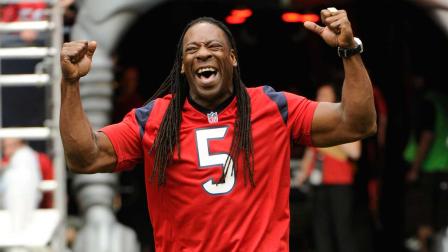 WWE wrestler and commentator Booker T reacts to the crowd before an NFL football game between the Baltimore Ravens and Houston Texans, Sunday, Oct. 21, 2012, in Houston. (AP Photo/Dave Einsel)