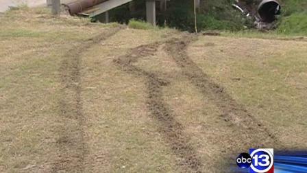 Tire marks remain where officials say a suspected drunken driver drove off the roadway and into a bayou, killing his passenger