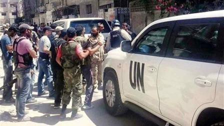 Syrian rebels escorted the UN investigation team, in Damascus countryside of Zamalka, Syria, Wednesday, Aug. 28, 2013