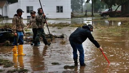 Local residents help salvage and clean property in an area inundated after days of flooding, in Hygeine, Colo., Monday Sept. 16, 2013