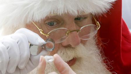 Actor Brady White portrays Santa Claus as he looks at a 25-carat rough Forevermark diamond