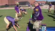 Football players embrace teammate with down syndrome