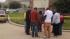 People hold hands and pray outside a crime scene in Cypress where two people died and 19 others were injured in a shooting at a party