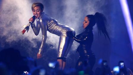 Miley Cyrus, left, and a dancer perform at the 2013 MTV Europe Music Awards in Amsterdam, Netherlands, Sunday, Nov. 10, 2013.