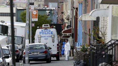 Crime scene personnel work at a crime scene in the Brooklyn section of New York