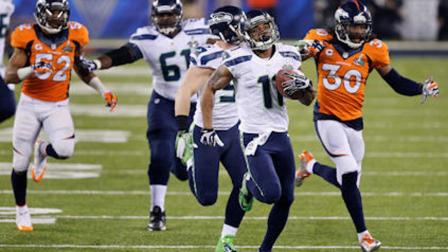 Seattle Seahawks Percy Harvin (11) runs from Denver Broncos David Bruton (30) while returning a kickoff 87-yards for a touchdown during the second half of the NFL Super Bowl XLVIII football game Sunday, Feb. 2, 2014, in East Rutherford, N.J. (AP Photo/Ted S. Warren)