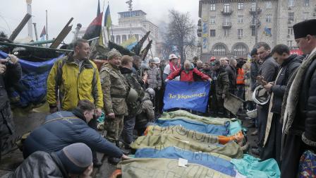 Activists and priests pay respects to protesters who were killed in clashes with police