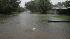 Water spews from a street drain at the corner of El Jardin Drive and Geraldine Street near the Pasadena/Seabrook border as street flooding is seen as a result of Tropical Storm Edouard on Tuesday, Aug. 5, 2008, in Pasadena. (AP Photo/Julio Cortez, Houston Chronicle )  