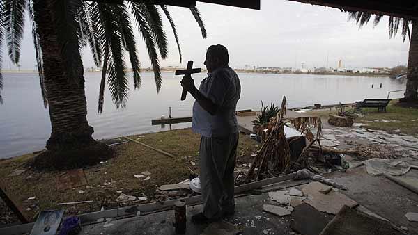 Galveston resident Ruben Rosas, 74, holds a cross which he found in the rubble of his apartment Wednesday, Sept. 24, 2008, in Galveston, Texas. This was Rosas first visit back to the island since Hurricane Ike came ashore. (AP Photo/Rick Bowmer)