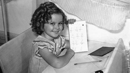 Shirley Temple, like any other little girl of 6 years, started to school and proved to be bright enough to win a gold star for her first days performance, Sept. 10, 1935, Hollywood, Calif.